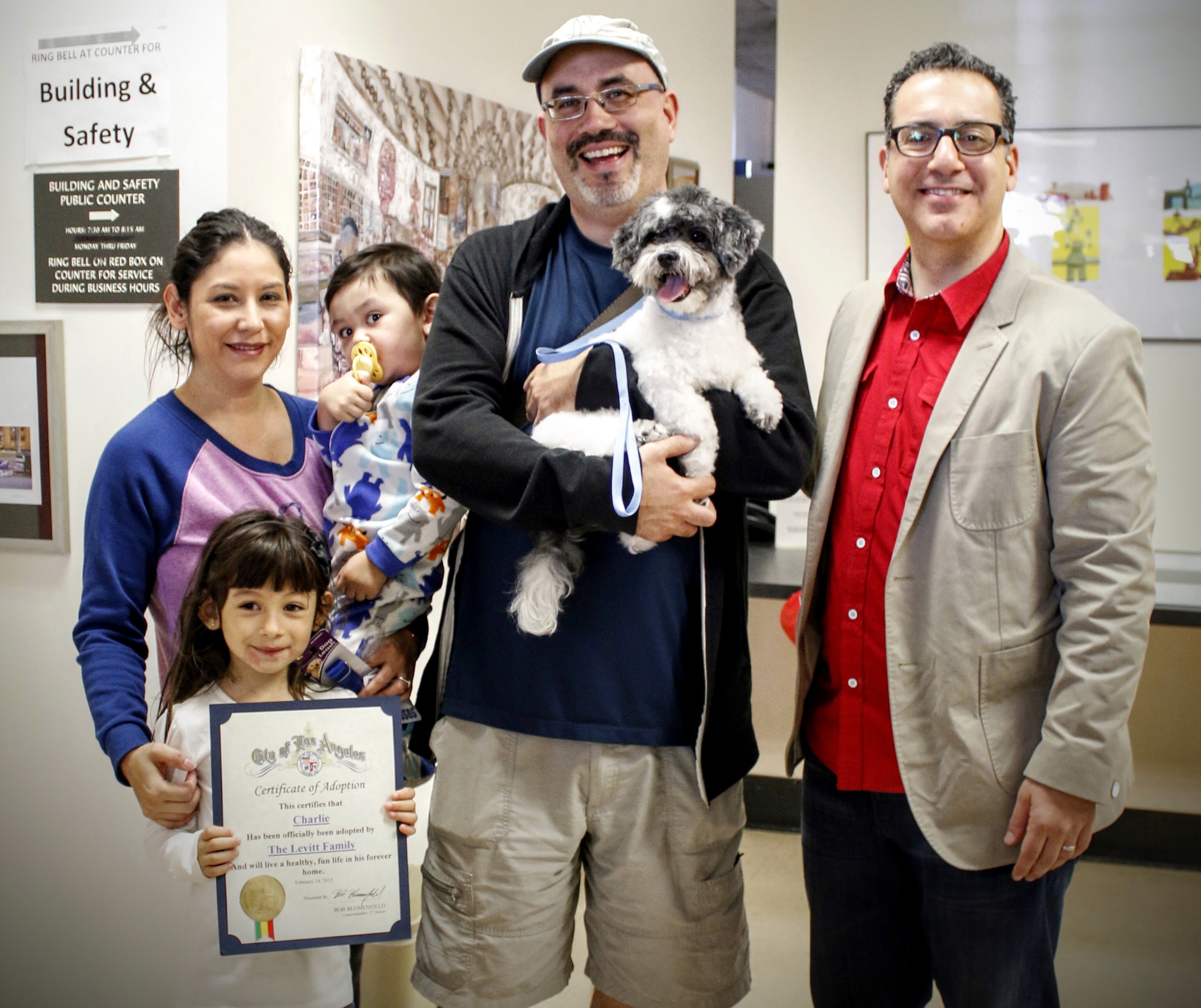 Blumenfield poses with Charlie, who was adopted by the Levitt family at the Valentine's Day Pet Fair